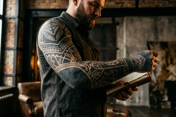 Dense black full sleeve tattoo before laser removal
