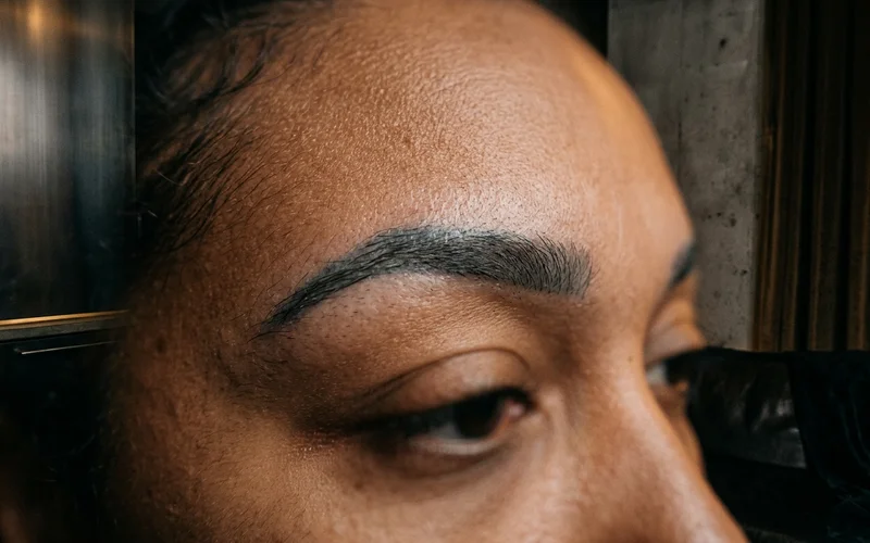 Detail of grey-blue toned permanent brow pigment on skin